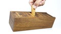 Hand is collecting pieces of wooden bricks in the box after playing Jenga game,Blocks wood Jenga game on white background Royalty Free Stock Photo