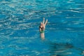 Hand coming out of the water, victory gesture Royalty Free Stock Photo