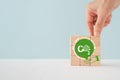 Hand complete co2 on green speech bubble over hand icon, Reduce CO2 emissions to limit climate change and global warming. Low Royalty Free Stock Photo