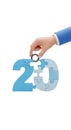 Hand completing the number 20 puzzle isolated on transparent background Royalty Free Stock Photo
