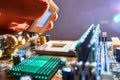 Hand of computer engineer replace computer cpu change components into socket processor for maintenance