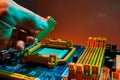 Hand of computer engineer replace computer cpu change components into socket processor for maintenance