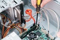 Omputer engineer with screwdriver is mount computer motherboard Royalty Free Stock Photo