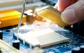 Hand of computer engineering brings computer cpu processor memory change components into socket processor for maintenance. Royalty Free Stock Photo