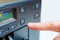 Hand Activates OK Button on Printer in Close-Up Royalty Free Stock Photo