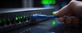 The hand connecting blue ethernet cable to a network router with glowing indicators. AI generated image Royalty Free Stock Photo