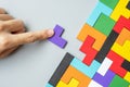 Hand connecting geometric shape block with colorful wood puzzle pieces. logical thinking, business logic, Conundrum, decision, Royalty Free Stock Photo