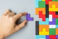 Hand connecting geometric shape block with colorful wood puzzle pieces. logical thinking, business logic, Conundrum, decision, Royalty Free Stock Photo