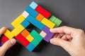 hand connecting geometric shape block colorful wood puzzle pieces logical thinking business logic conundrum decision solutions Royalty Free Stock Photo