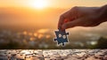 Hand connecting jigsaw puzzle piece on sunset background. Business solution concept