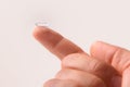 Hand with contact lens on finger side view Royalty Free Stock Photo