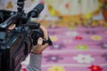 Hand control Video camera operator camcorder working with his equipment outdoor with blurred background . Close up short of video Royalty Free Stock Photo