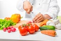 Hand cook cut vegetables for salad close up