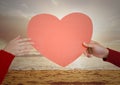 Hand of couple holding red heart on beach Royalty Free Stock Photo