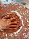 A hand covered in clay