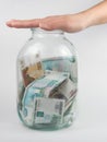 Hand covered three-liter jar with Russian money Royalty Free Stock Photo