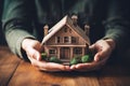 Hand covering an example house as a symbol of home insurance and protection AI Generated Royalty Free Stock Photo