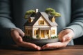 Hand covering an example house as a symbol of home insurance and protection AI Generated Royalty Free Stock Photo