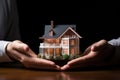 Hand covering an example house as a symbol of home insurance and protection AI Generated Royalty Free Stock Photo