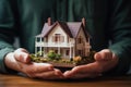 Hand covering an example house as a symbol of home insurance and protection AI Generated Royalty Free Stock Photo