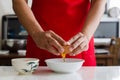 Hand cracking egg into a bowl for cooking