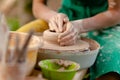 Hand craft making pottery on wheel. Female hands mold ceramic plate from clay pot Royalty Free Stock Photo