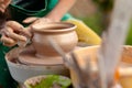 Hand craft making pottery on wheel. Female hands mold ceramic plate from clay pot Royalty Free Stock Photo