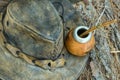 Hand Crafted Artisanal Yerba Mate Tea Leather Calabash Gourd with Straw Hat on Wood Logs in Forest. Travel Wanderlust Concept. Ear Royalty Free Stock Photo