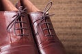 Hand crafted Brown Leather Shoes kept on a Wooden Floor