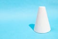 hand-crafted paper frustum cone on turquoise blue Royalty Free Stock Photo