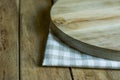 Hand Crafted Round Wood Cutting Board on Folded Cotton Checkered Kitchen Towel Plank Table Royalty Free Stock Photo