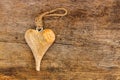 Hand crafted wooden heart with rope to hang on rough weathered w