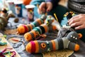 hand crafting sock puppets with glue, yarn, and googly eyes on a table