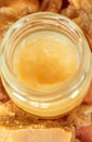 Hand cream or lip balm in a glass jar. Natural organic cosmetics with honey, wax and oils