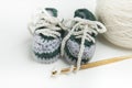 Hand crocheted baby shoes with wool, crochet needle