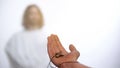 Hand with cross stretching out to Jesus, believer asking God for help, healing Royalty Free Stock Photo