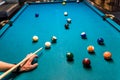 Hand with cue aiming on billiard ball at table Royalty Free Stock Photo