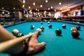 Hand with cue aiming on billiard ball at table Royalty Free Stock Photo