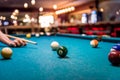 Hand with cue aiming on billiard ball at table Royalty Free Stock Photo