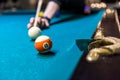 Hand with cue going hit a ball Royalty Free Stock Photo