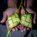 Hand Cupping Ketupat Pouch. Ketupat is a type of dumpling made from rice packed inside a diamond-shaped container of woven palm