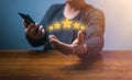 hand of customer or client holding the stars to complete five stars. with copy space. giving a five star rating. Service rating, Royalty Free Stock Photo