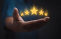 hand of customer or client holding the stars to complete five stars. with copy space. giving a five star rating. Service rating, Royalty Free Stock Photo