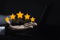 hand of customer or client holding the stars to complete five stars. with copy space. giving a five star rating. Service rating, Royalty Free Stock Photo