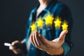 hand of customer or client holding the stars to complete five stars with copy space.Service rating,giving a five star rating. Royalty Free Stock Photo