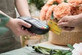 Hand of customer paying with contactless credit card in flower shop. Royalty Free Stock Photo