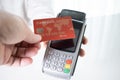 Hand of customer paying with contactless credit card with NFC technology. Royalty Free Stock Photo