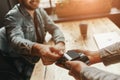 All you need. Cheerful man in cafe giving credit card to waiter Royalty Free Stock Photo