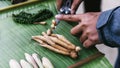 Hand cut fresh ginger by knife and many spices on banana leaves. Example of spicy and aromatic taste of coffee