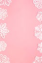 Hand cut white paper snowflakes frame on the pink background. Christmas or New Year concept greeting card. Royalty Free Stock Photo